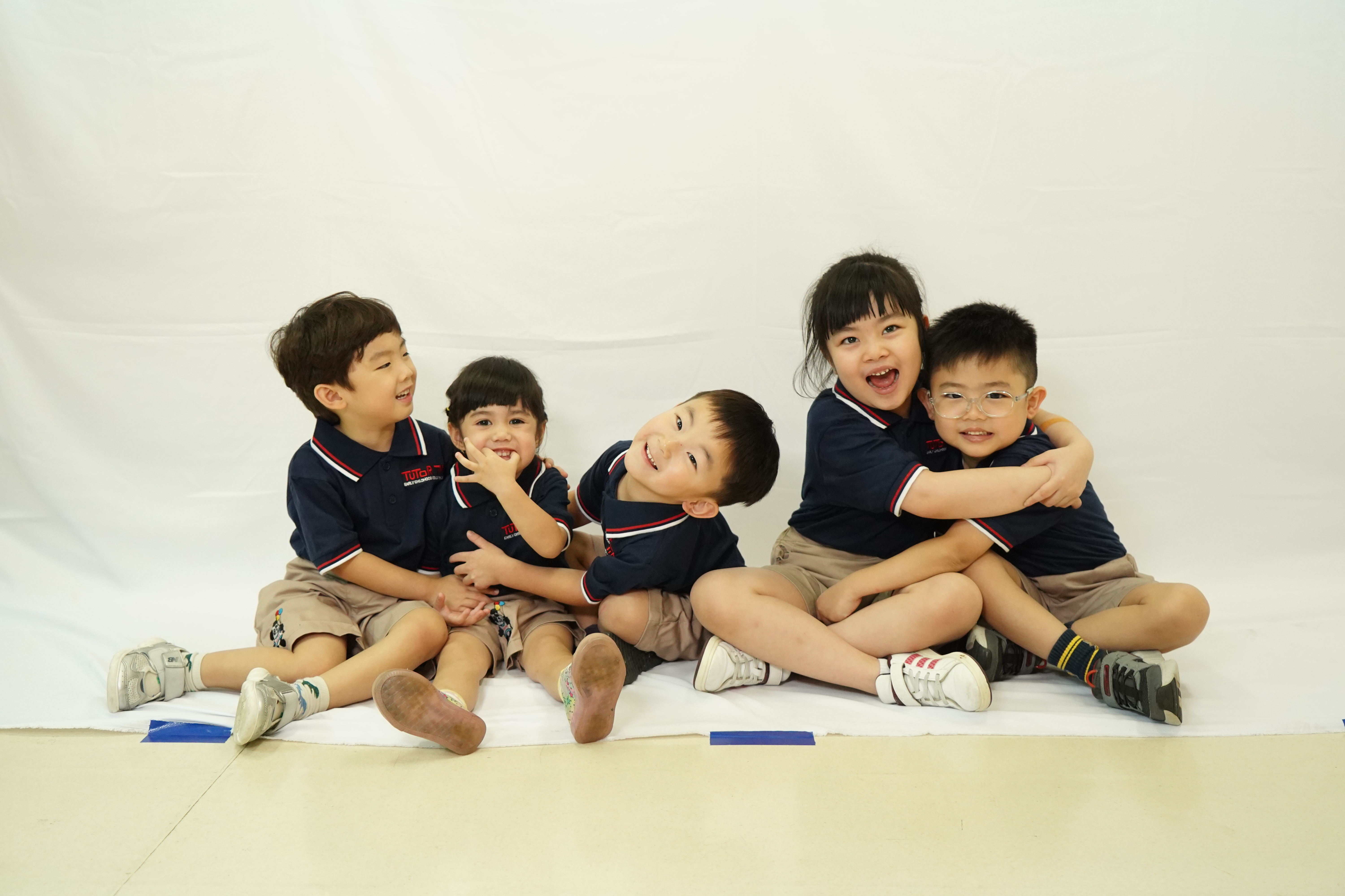 Tutor Time students laughing and hugging — international preschool Indonesia